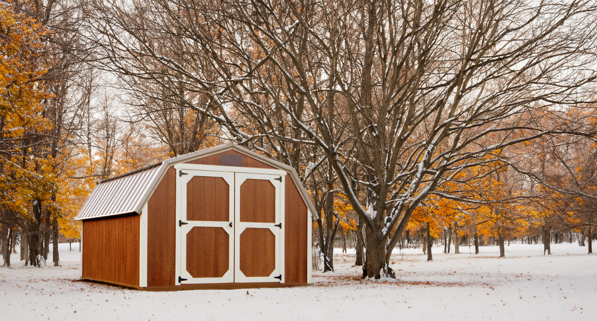 Brown wooden barn in a snowy yard from JCM Rentals located in Ina, Illinois